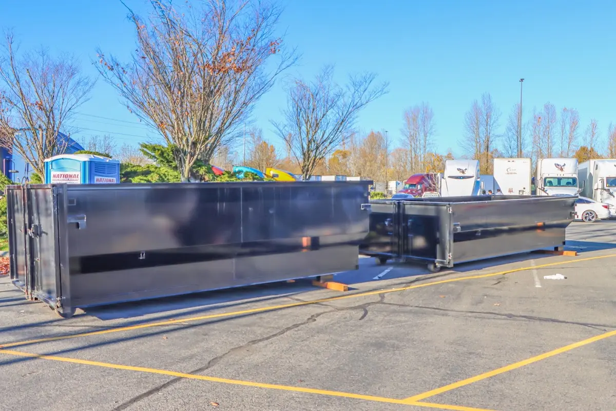 Professional dumpster rental service with roll-off container on residential driveway in Siesta Key